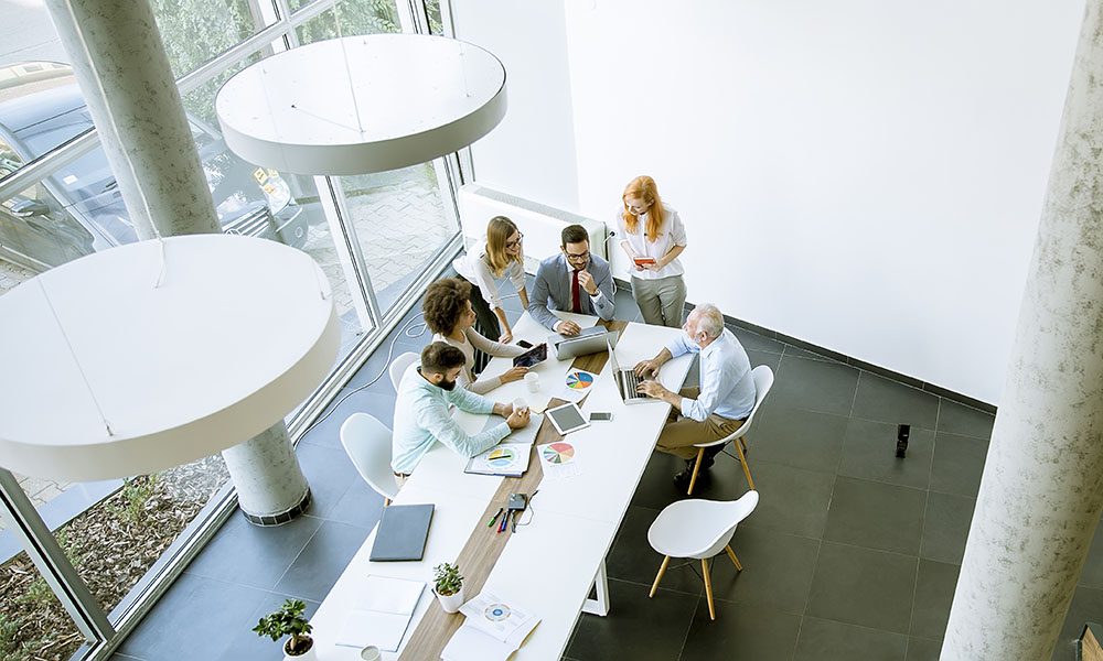 News and Updates - Group of Employees Sitting in Modern Office During Team Meeting